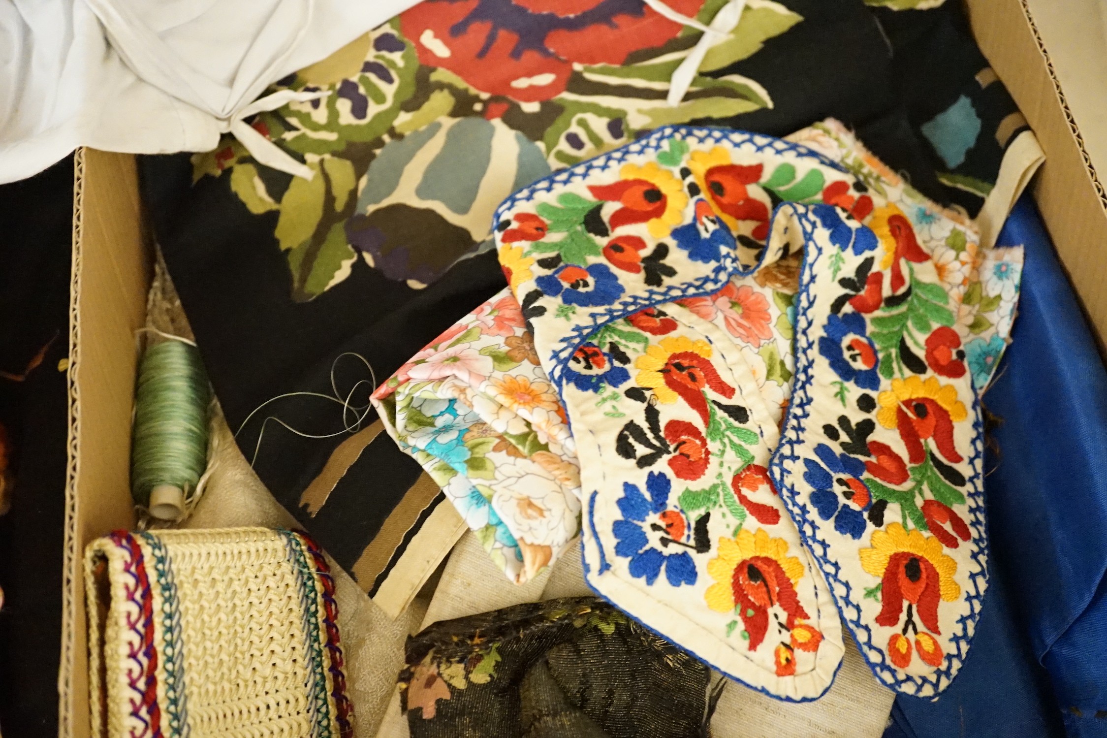 A large collection of mixed European textiles including ribbon worked pyjama cases, Indian painted textiles, a sample book of braidings etc